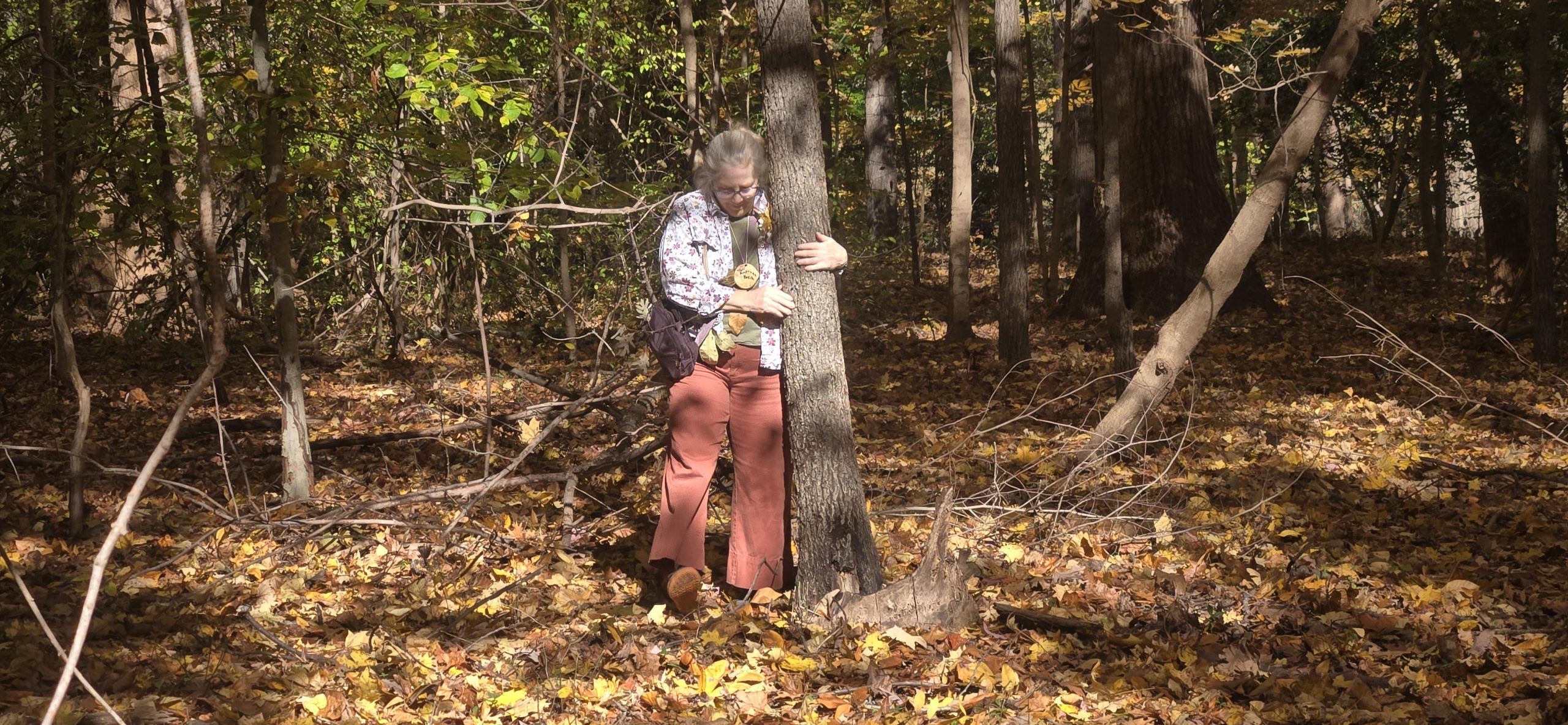 A tree hugging contestant hugs a tree